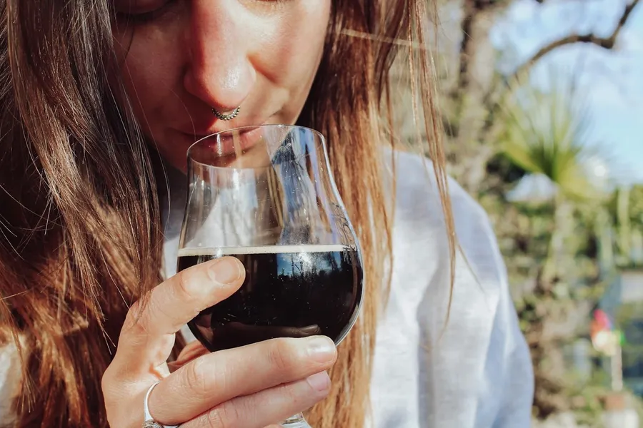 a woman drinking a glass of wine - mejores libros para aprender de vinos