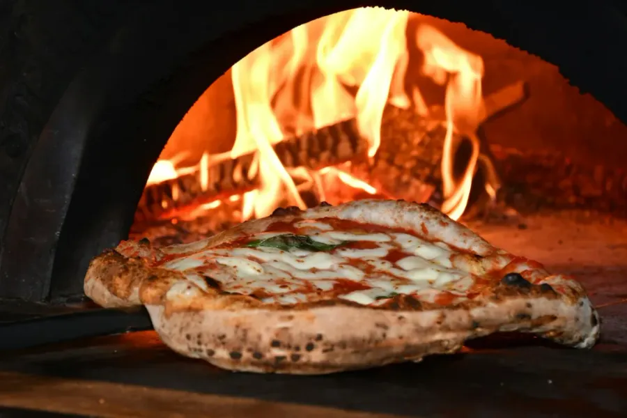 el puto amo - pizza on brown wooden table